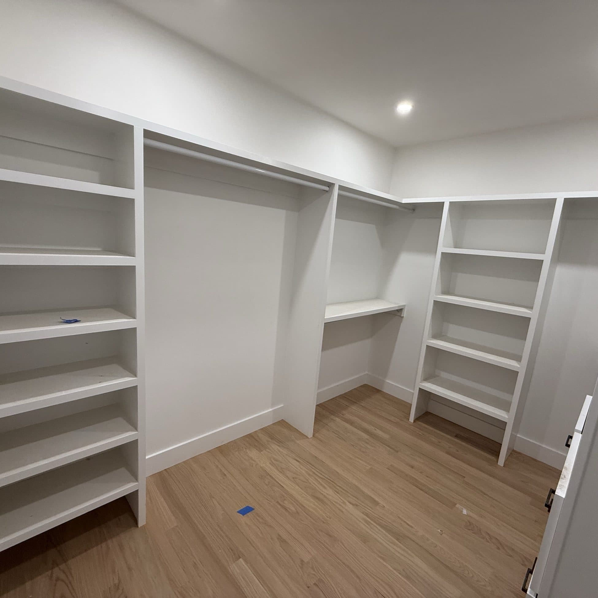 Walk-in closet with freshly finished white shelving