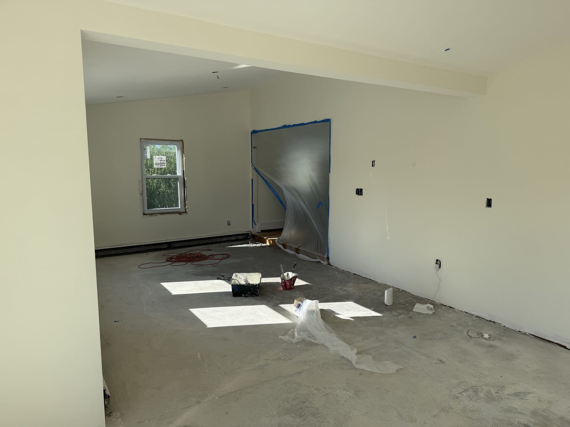 Room prepared for painting with fresh drywall and primer