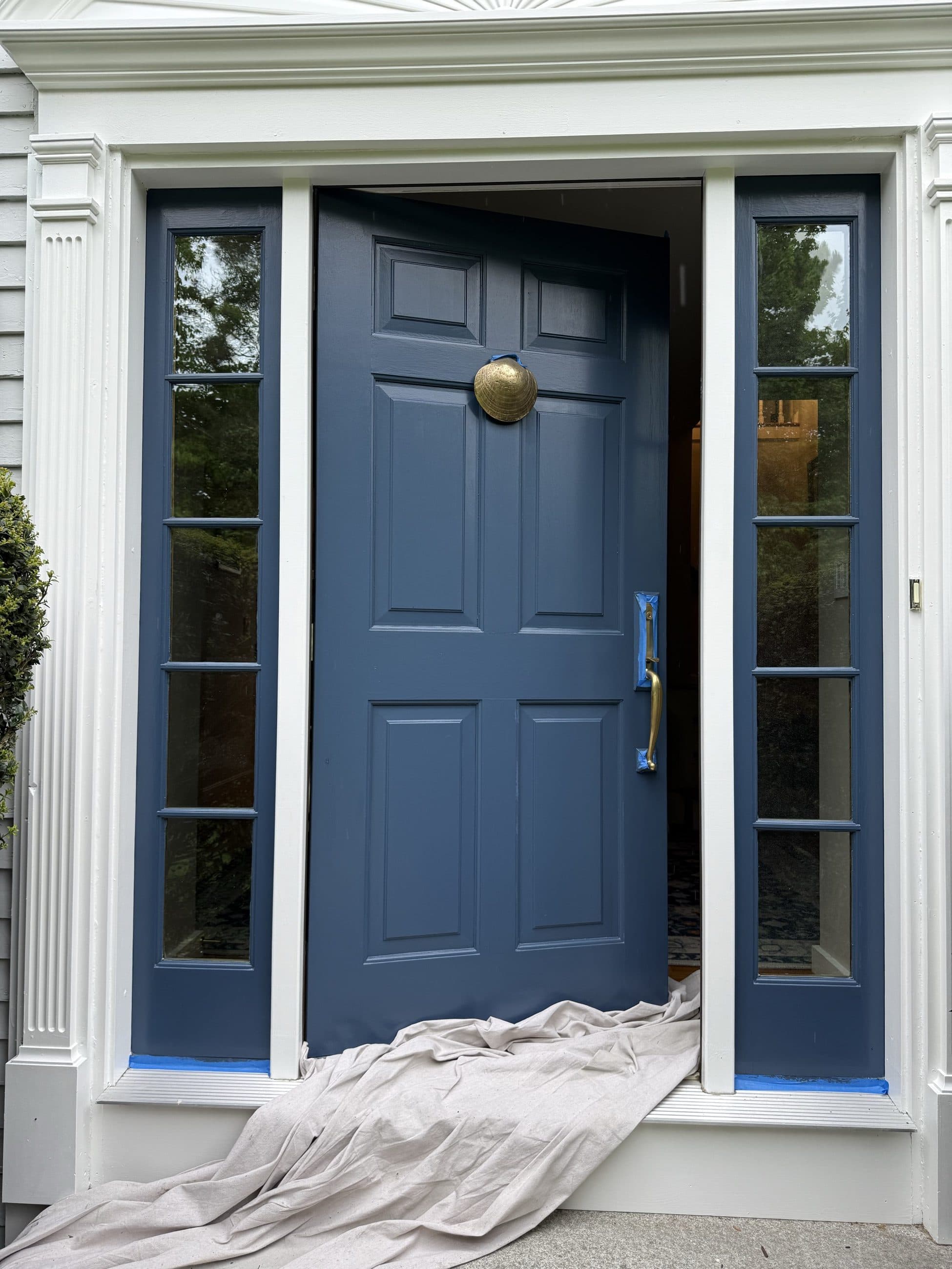 Navy front door with fresh white casing