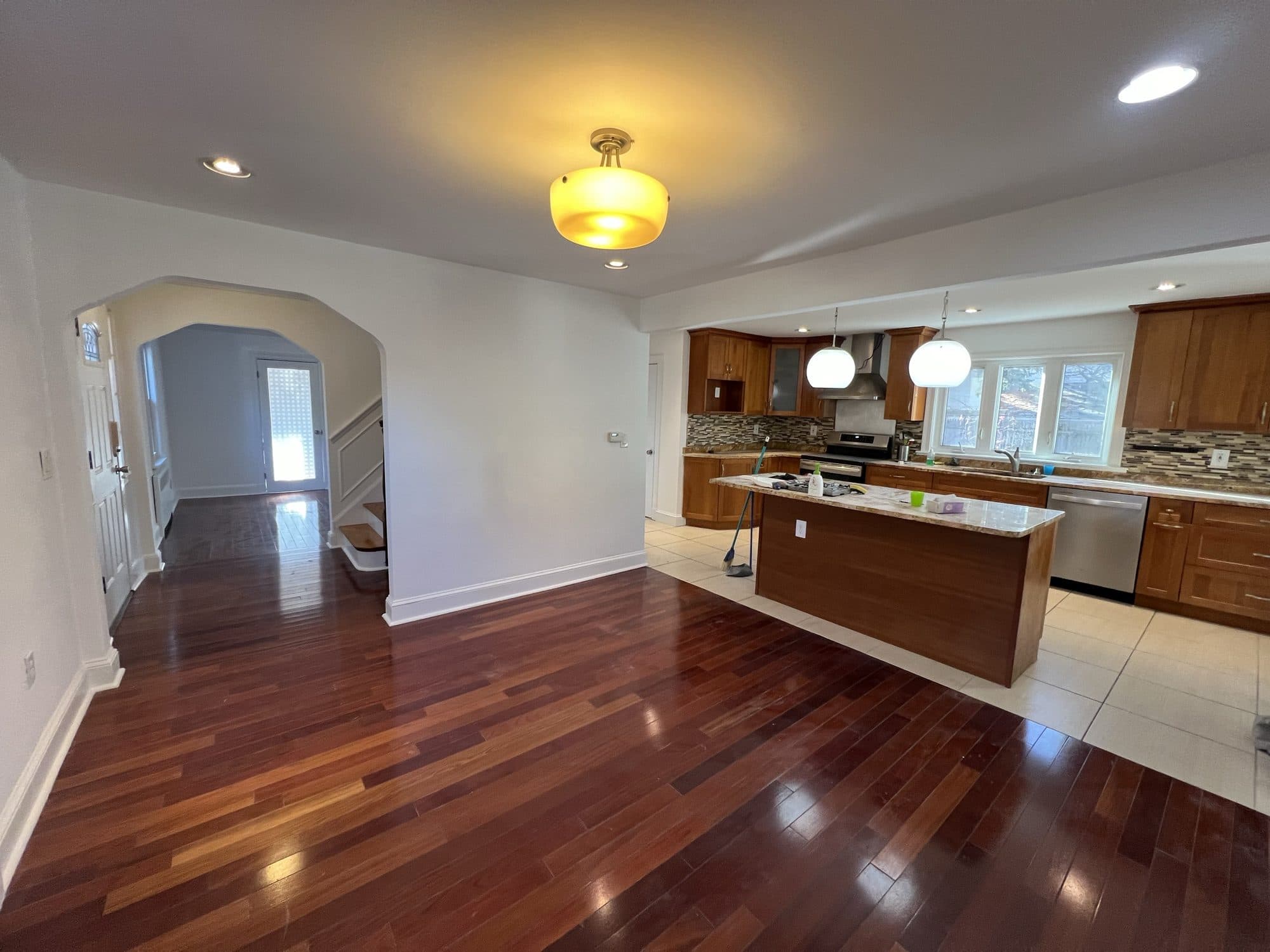 Kitchen and hallway with glossy cherry hardwood floors