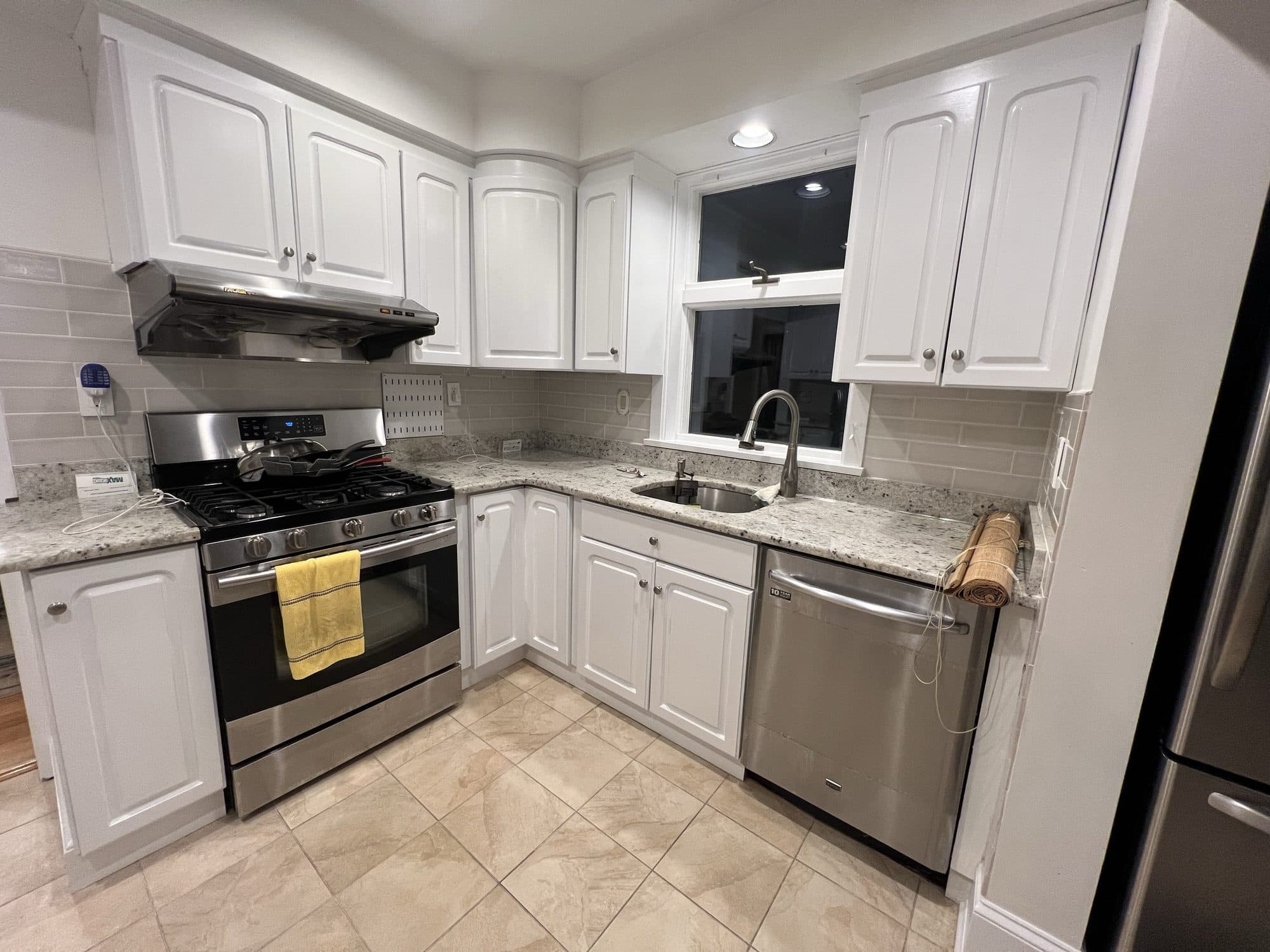 Compact white kitchen with stainless appliances