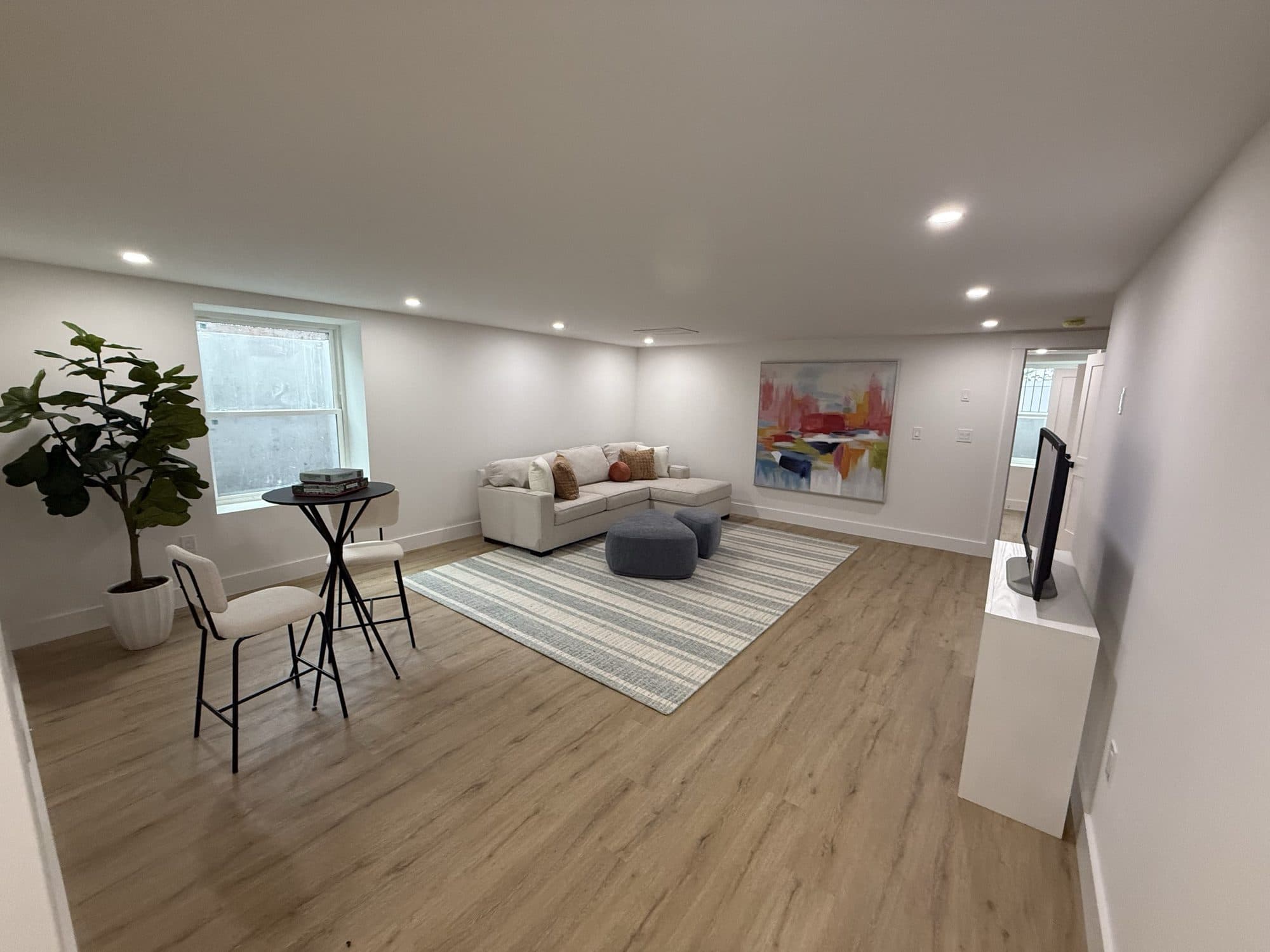 Staged living room with warm oak floors