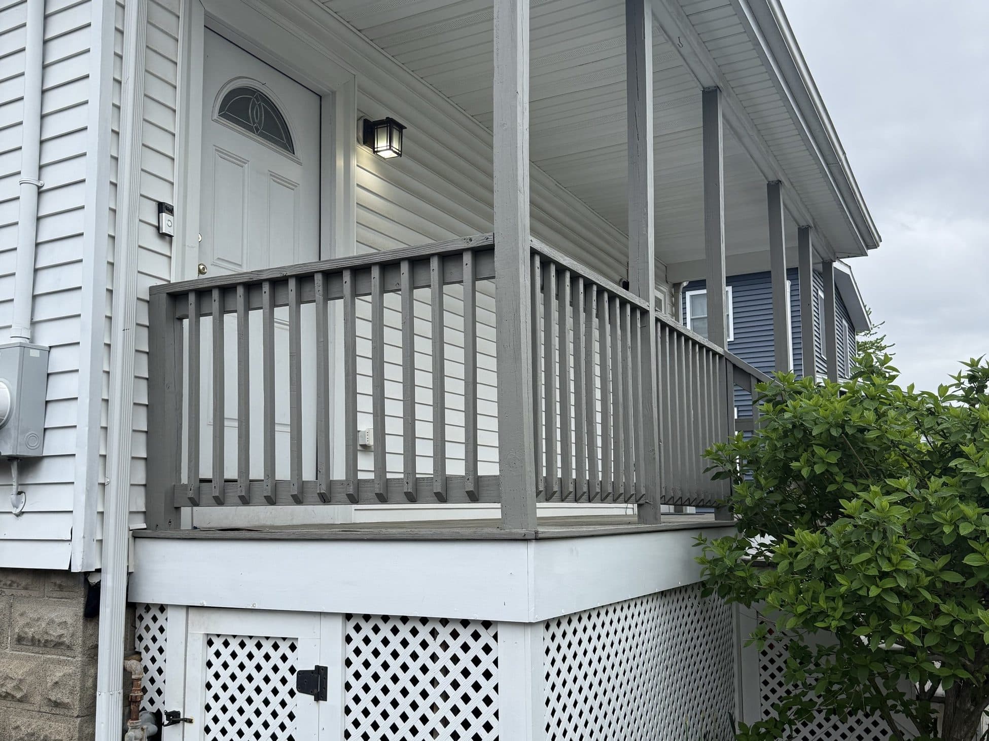 Porch railing and lattice skirt in fresh white and grey