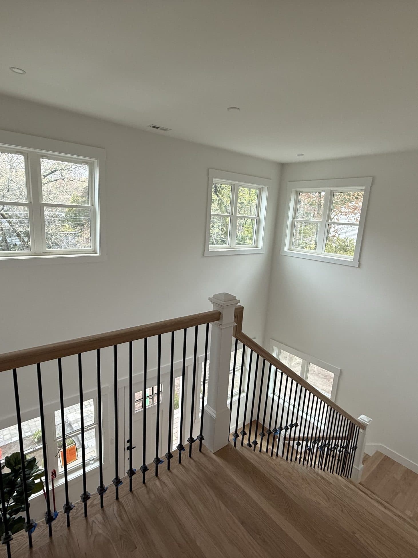 Staircase and landing with white railings and oak treads
